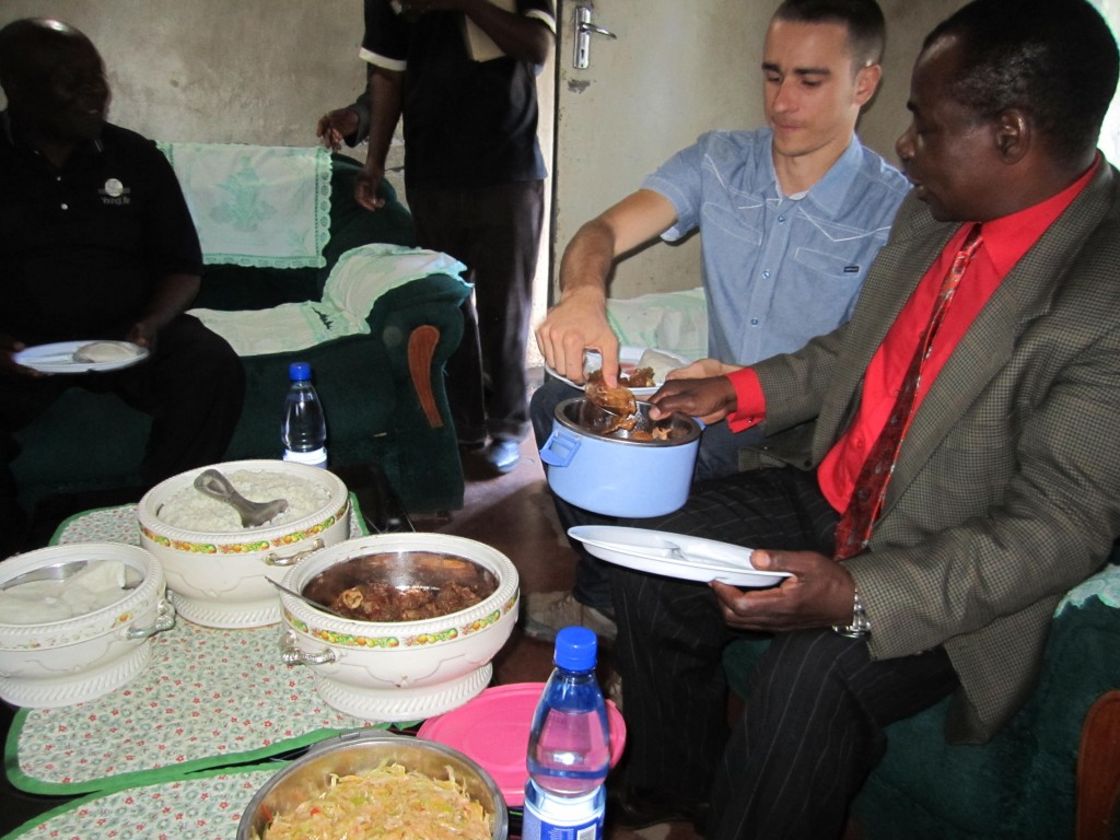 Jared eating Nsima & Nkuku with Pastors in Africa