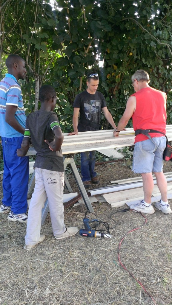 Jared and crew installing steel siding on Kadoma orphan care center, Zimbabwe.